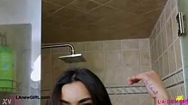 Stunning bronze skin model taking a shower in photoshoot