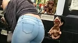 teen latina with tight jeans showing off her curves in a voyeur scene