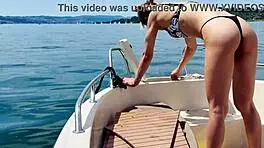blonde housewife washes boat in sexy thong swimsuit for summer fun.