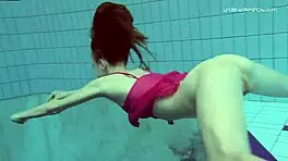 Anna netrebko teases in bikini while swimming in the pool, showing off her petite figure.