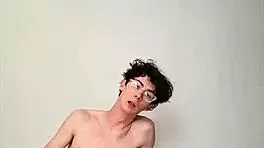 On a sunny day, this horny young teen masturbates with a big cock on the bed, getting cum covered.