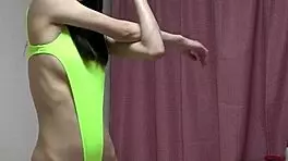 Petite girl changes from leotard to bikini