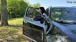 Crazy girl pees on the car roof to clean the windshield.
