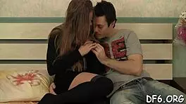 Fragile teen reveals tight pink pussy for camera, contrasting innocence with hardcore desires.