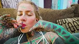 Tattoo girl feels pleasure in solo anal play with big dildo in sexy fishnets