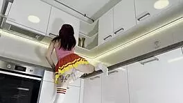 Hottest Redhead Tattooed Cheerleader With Over Knee Socks Shows Her See Through Panties In The Kitchen