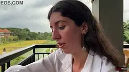 Enjoying a mouthful of pizza on the street in a public cafe with beautiful teen