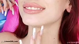 Red-haired model casually reveals her sexy body on sofa.