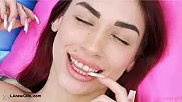 Red-haired model casually reveals her sexy body on sofa.