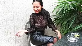 Young girl smokes topless in leather skirt