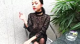 Young girl smokes topless in leather skirt