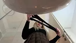 Hot blonde babe with big tits and ass strips in pantyhose and heels in bathroom