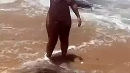 Young African Woman Flashes On The Beach