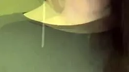 The pregnant woman pulls her milky tits out of her red bra