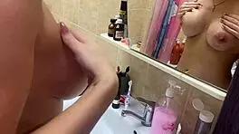 Intensely aroused spying on voluptuous big tits in the bathroom, her passionate masturbation thrilling me.