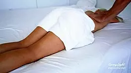 Curvy woman enjoys oiled massage session