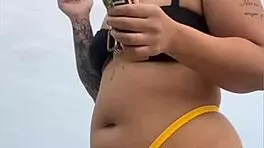 Young african woman in tight yellow bikini at usa beach