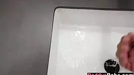 young babe gives teasing oral in steamy bathroom