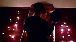 Romantic couple shares intimate lovemaking under moonlit night